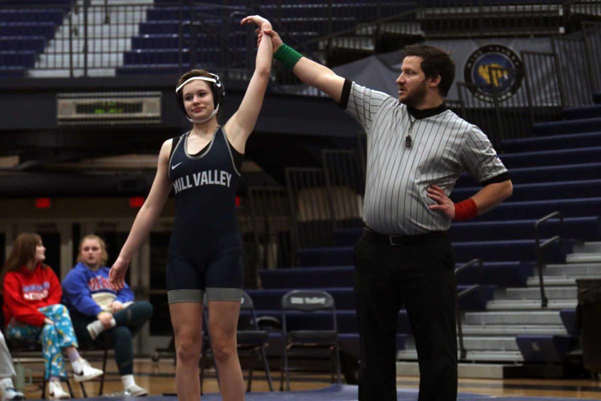 Hand raised, the referee declares freshman Chris Hale the winner of her match.