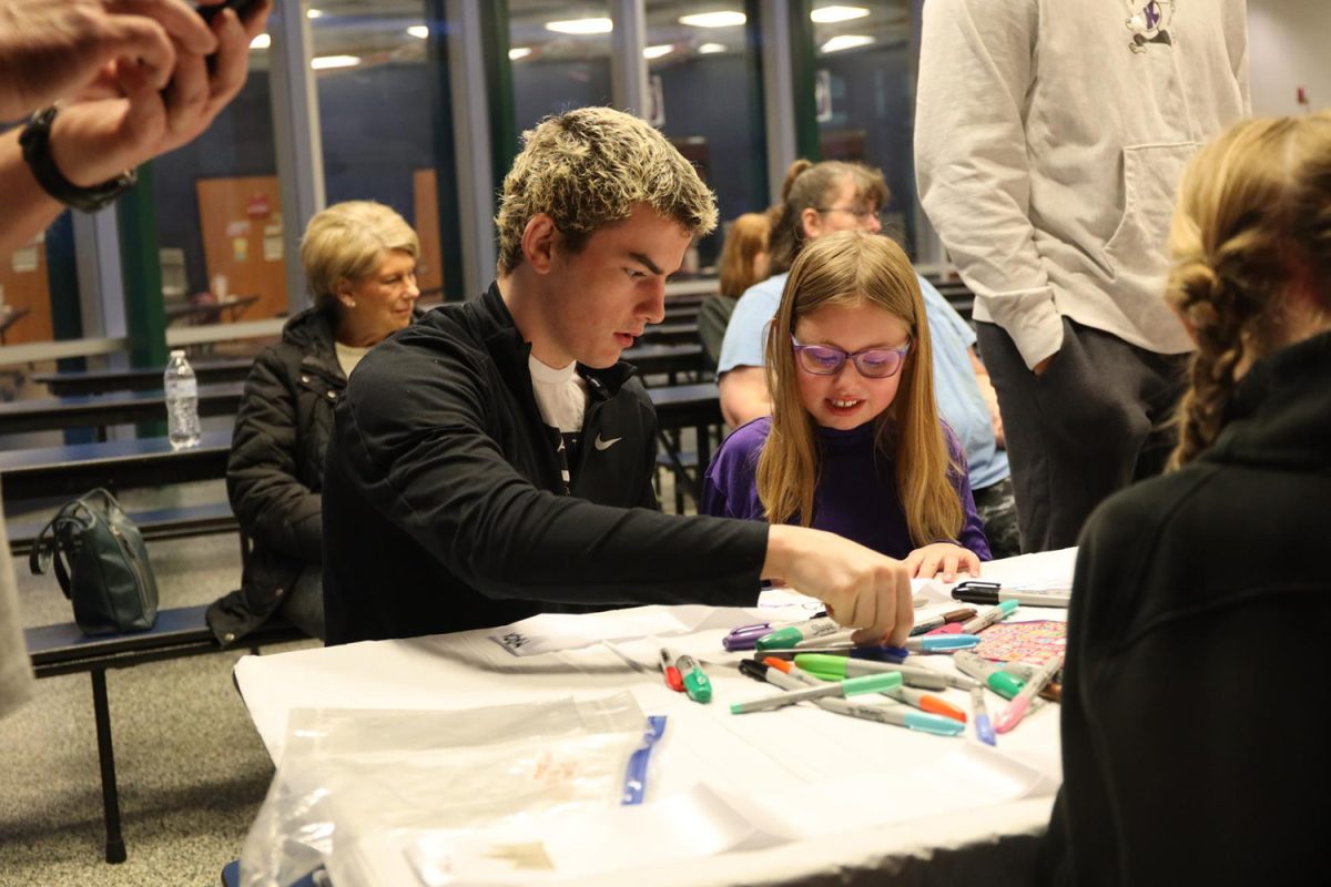 Picking out colors for his sash, senior Maddox Casella plans out what to draw Wednesday Jan. 31.