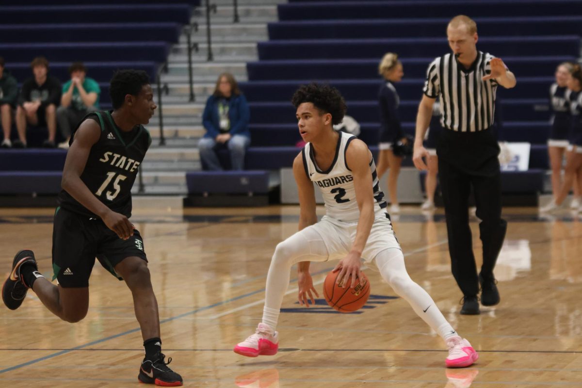 Sophomore JaKhai Carter dribbles between his legs to slow the game down.