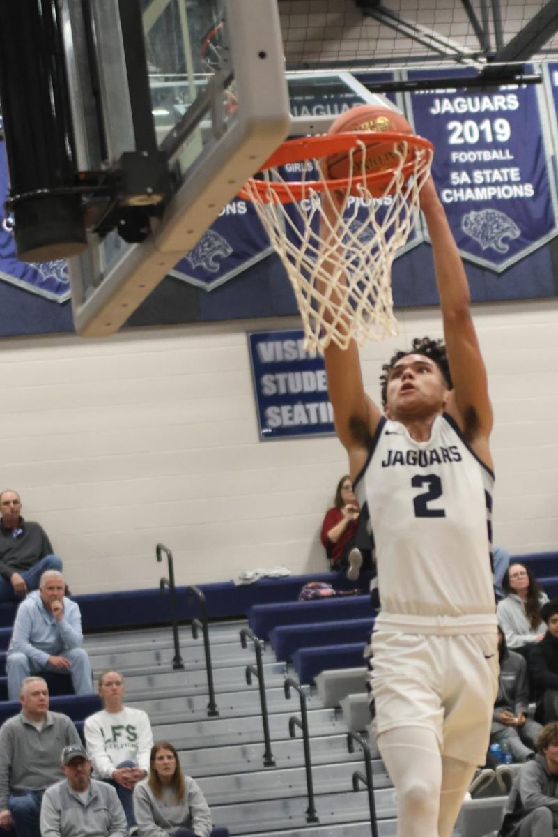 Sophomore JaKhai Carter goes up to dunk.