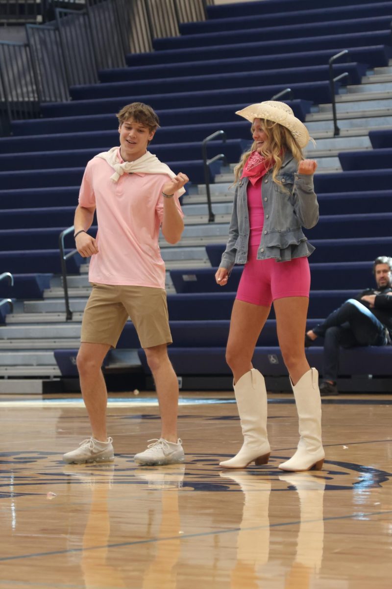 In their Barbie and Ken inspired outfits, winter homecoming candidates seniors Sam Colletti and Julia Coacher dance to “Barbie World.”