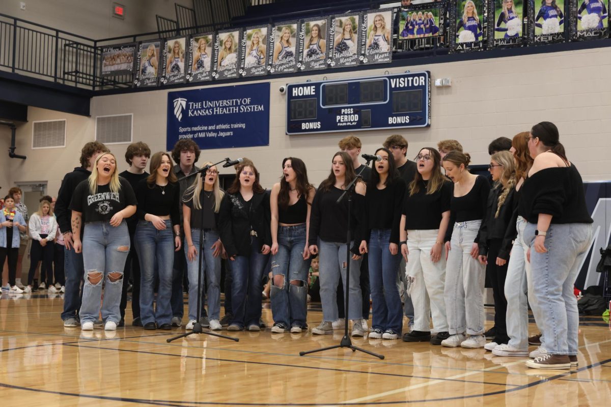 In unison, choir sings “Apple Tree” at the winter homecoming pep assembly.