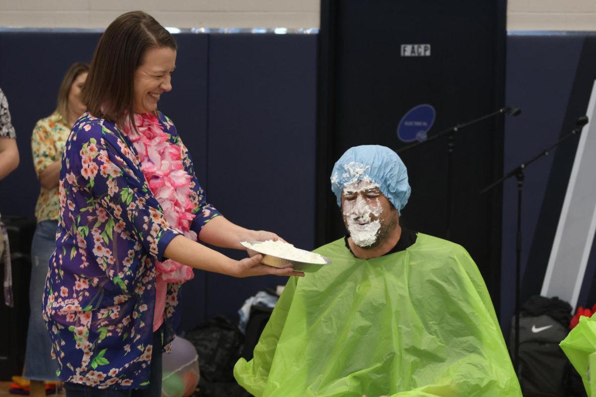With a smile on her face, librarian Ashley Agre pies English teacher Mike Strack.