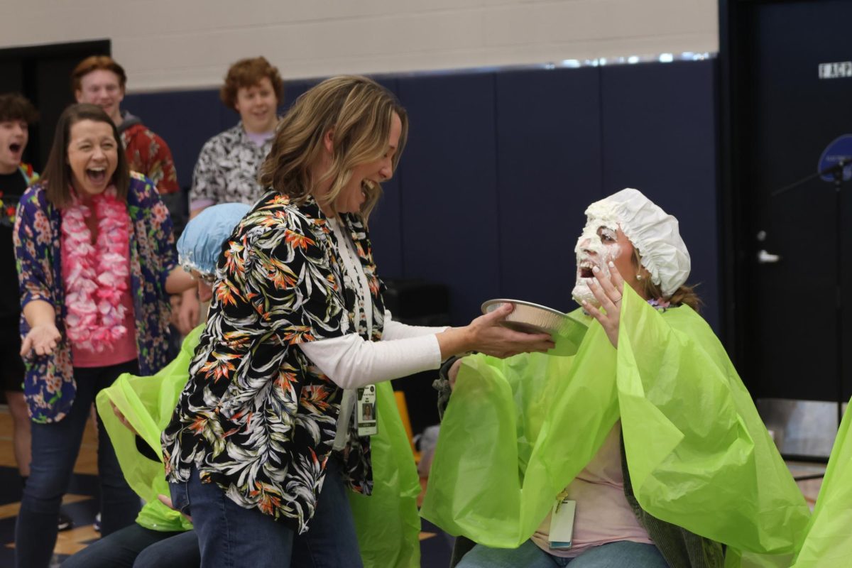With a shocked expression, counselor Erin Hayes pies FACS teacher Lauren Stringer.
