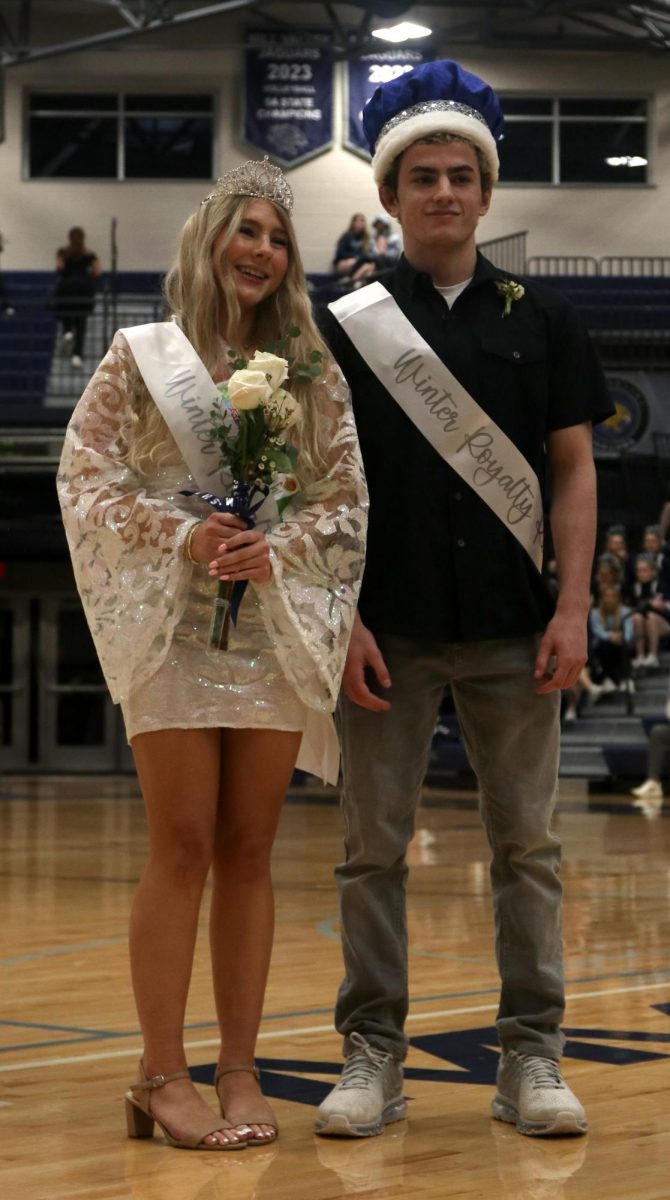 After being announced winter homecoming king and queen, seniors Violet Hentges and Maddox Casella smile for a picture. 