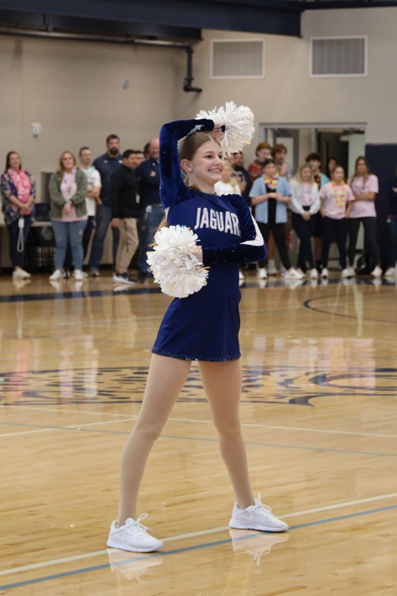 With a smile on her face, sophomore Ella Jones poses towards the audience during her performance.