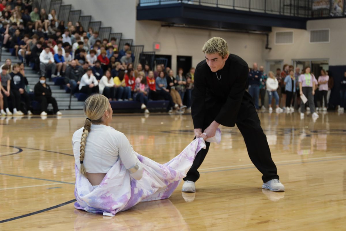 In his ready stance, winter homecoming king candidate senior Maddox Casella prepares to pull winter homecoming queen candidate senior Brooke Bellehumeur across the gym floor.