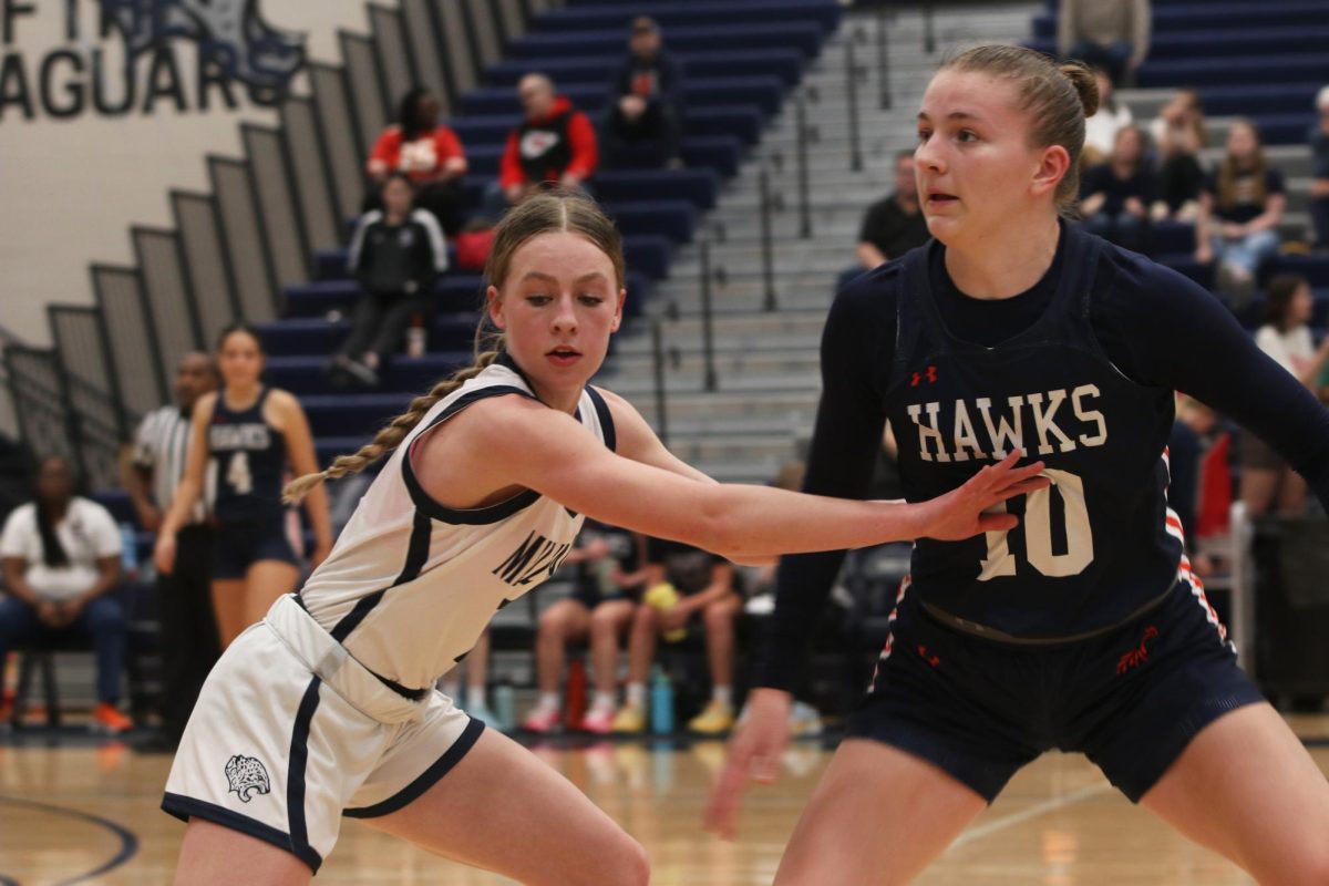 Offering her teammate an escape, junior Josie Benson stands on guard.