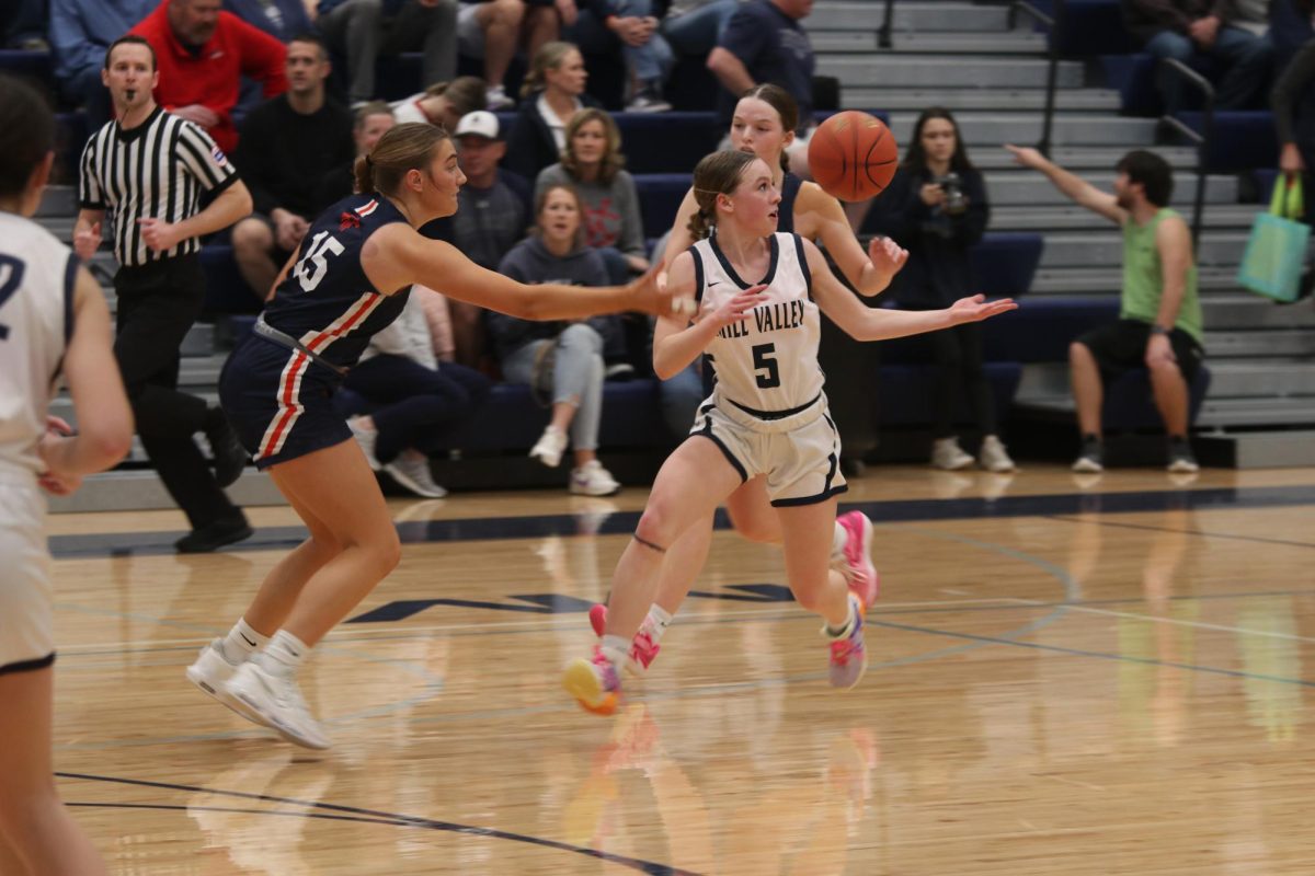 Taking action, junior Josie Benson sprints in front of her opponent to try and retrieve the ball.