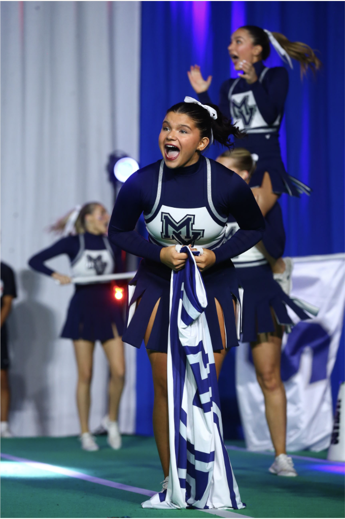 Yelling towards the crowd, sophomore Ava Lucht gets ready for the cheer Saturday, Jan. 20. 