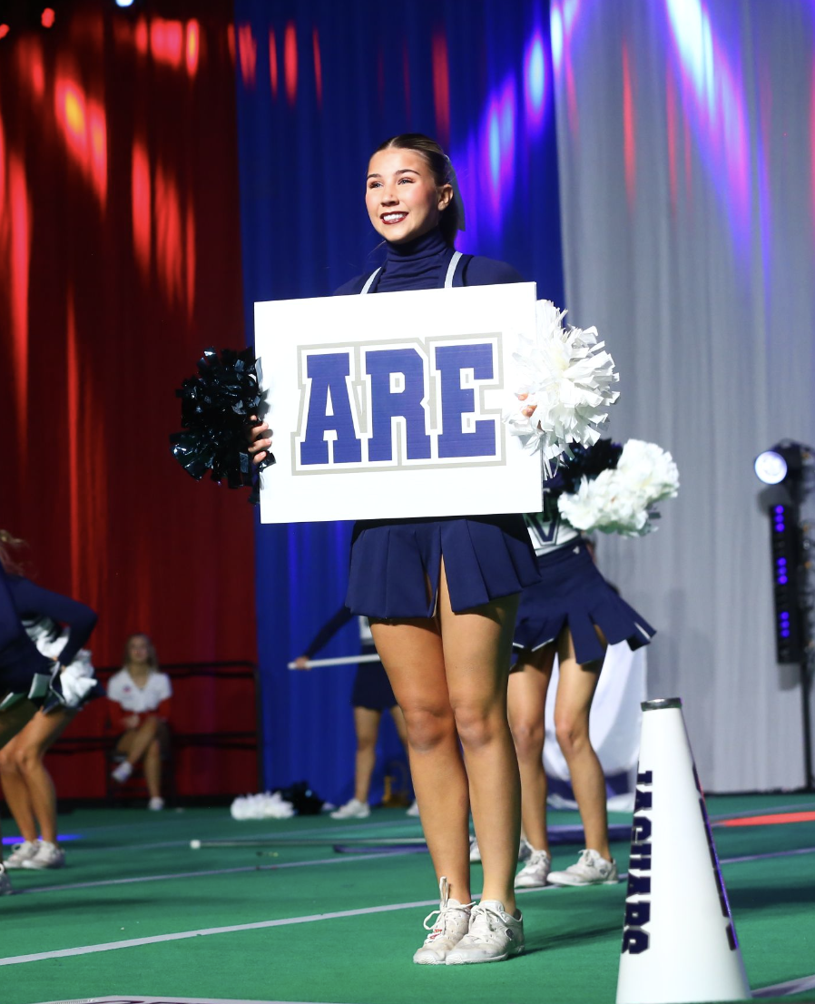 Holding her sign in her hand, sophomore Sydney Epperson smiles towards the crowd Saturday, Jan. 20. 