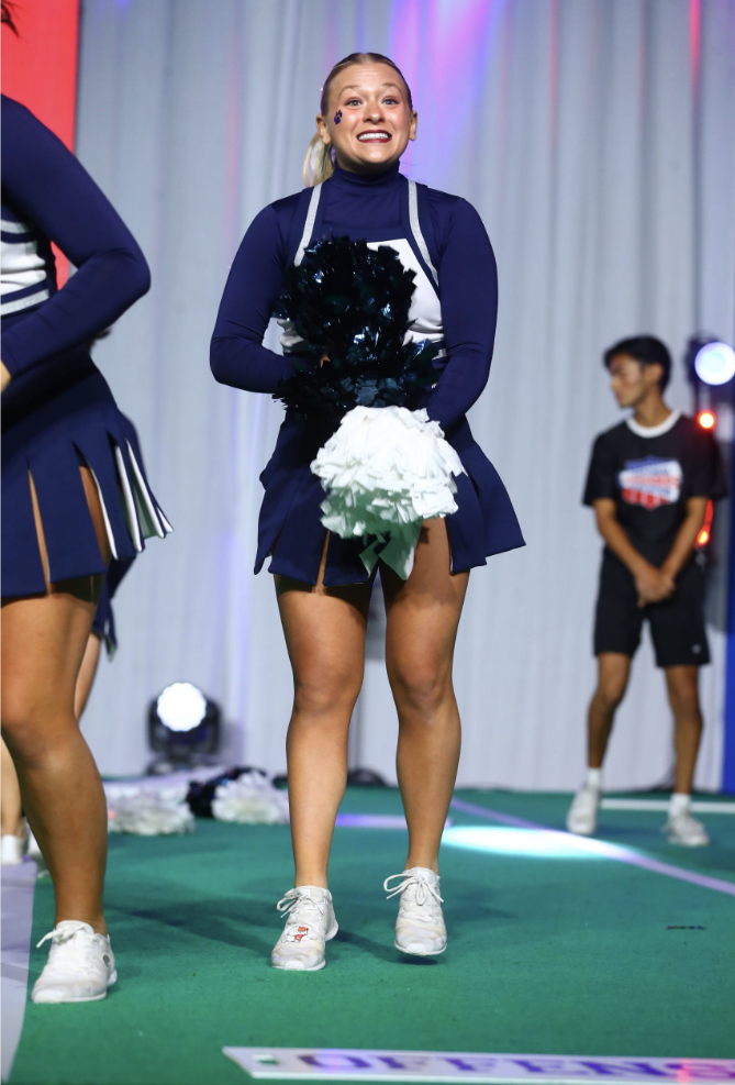 Shaking her poms, senior Danika Dulitz brings spirit on the floor Saturday ,Jan. 20. 