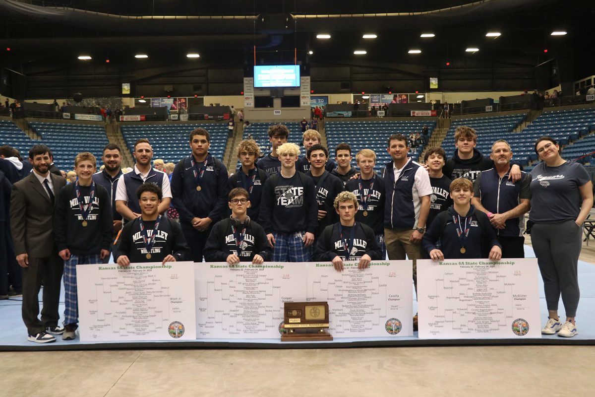 The boys wrestling team poses with the team second place trophy after the tournament Saturday, Feb. 24 in Wichita.