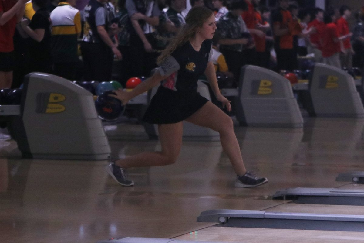 Focusing on the pins, sophomore Abby Haney goes to bowl the ball. 
