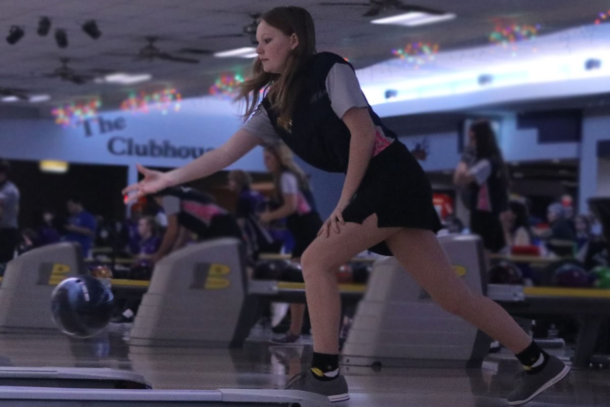 Tossing the ball, freshman Rylee Slaven tries to go for a strike. Slaven bowled a series of 296 at the meet.