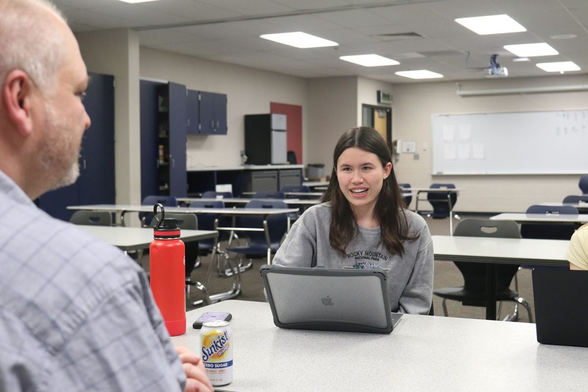 Discussing with forensic teacher Shawn Rafferty, junior Sophie Hsu runs through her document on student athletes. 
