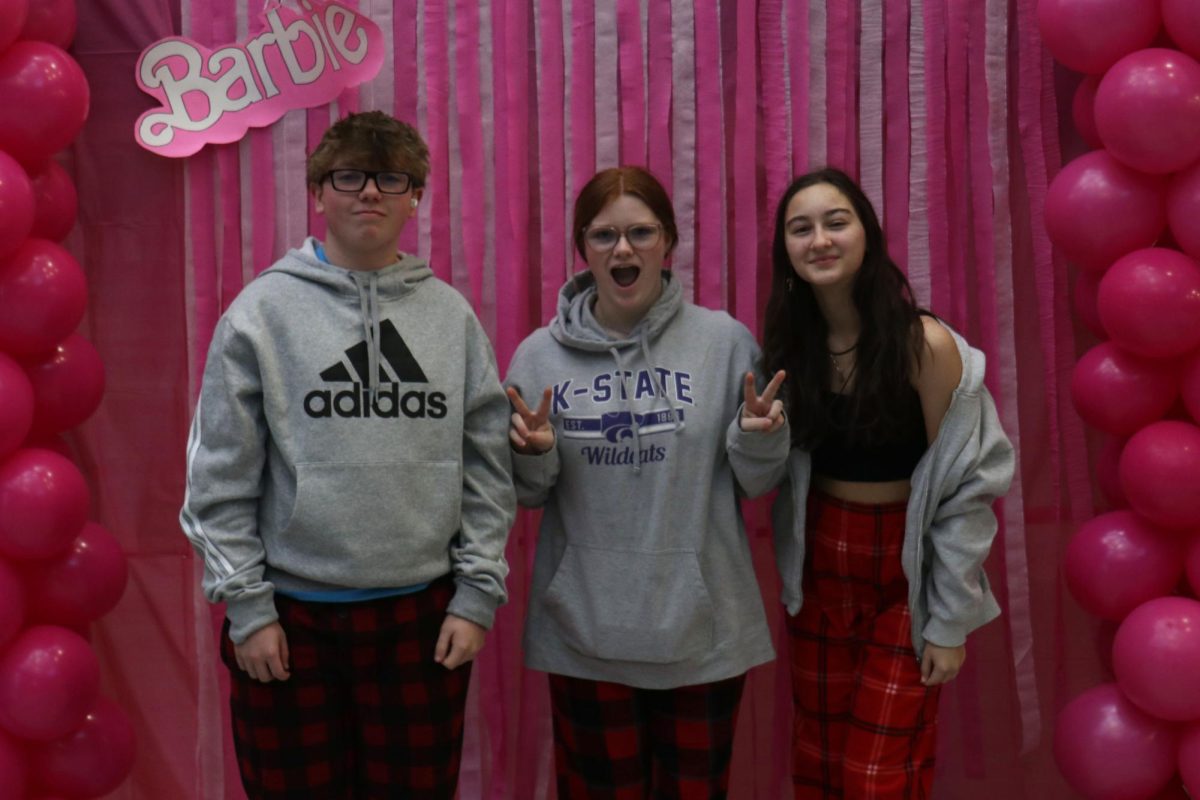 Wearing pajamas, freshmen Charlie Barrett and sophomores Reagan Thate and Chance McCall pose together Monday Jan. 29.