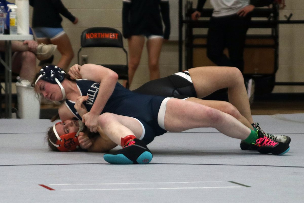 Pinning the opponent to the ground, junior Piper Wendler wins her match.