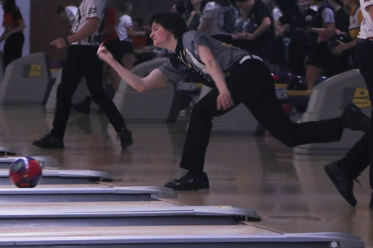 Hoping for another strike, senior Ethan Diehl throws his bowling ball down the alley. Diehl bowled a series of 680 at the meet which earned him second place individually. The boys team bowled a combined series of 2521 to earn first place overall.