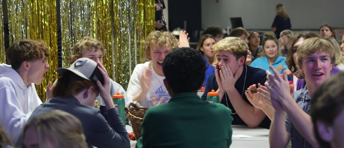 Seniors Gage Graham, Noah Brueggemann, Aiden Stroebel, Jack Fulcher, and Lucas Longhofer celebrate together after getting the question right.