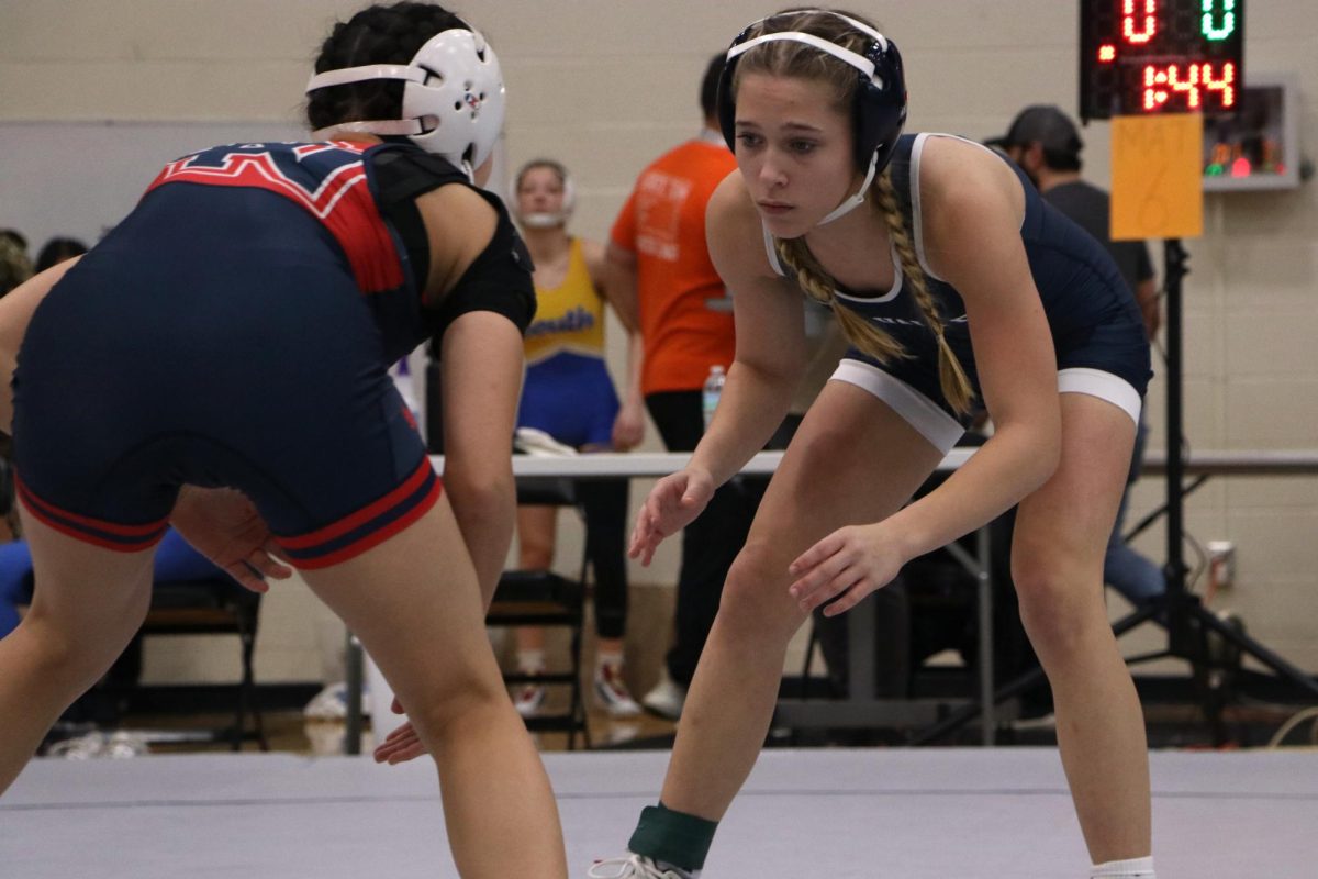 Eyes on her opponent, junior Raina Frantz thinks about her next move.