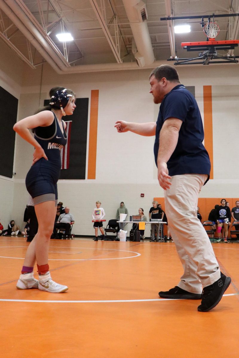 In a conversation, freshman Chris Hale has a debrief moment with her coach.