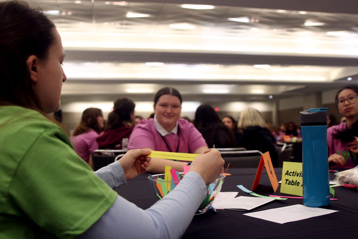 At the many tables around the room, mentors lead their tables in get-to-know-you discussions, using colorful slips of paper.