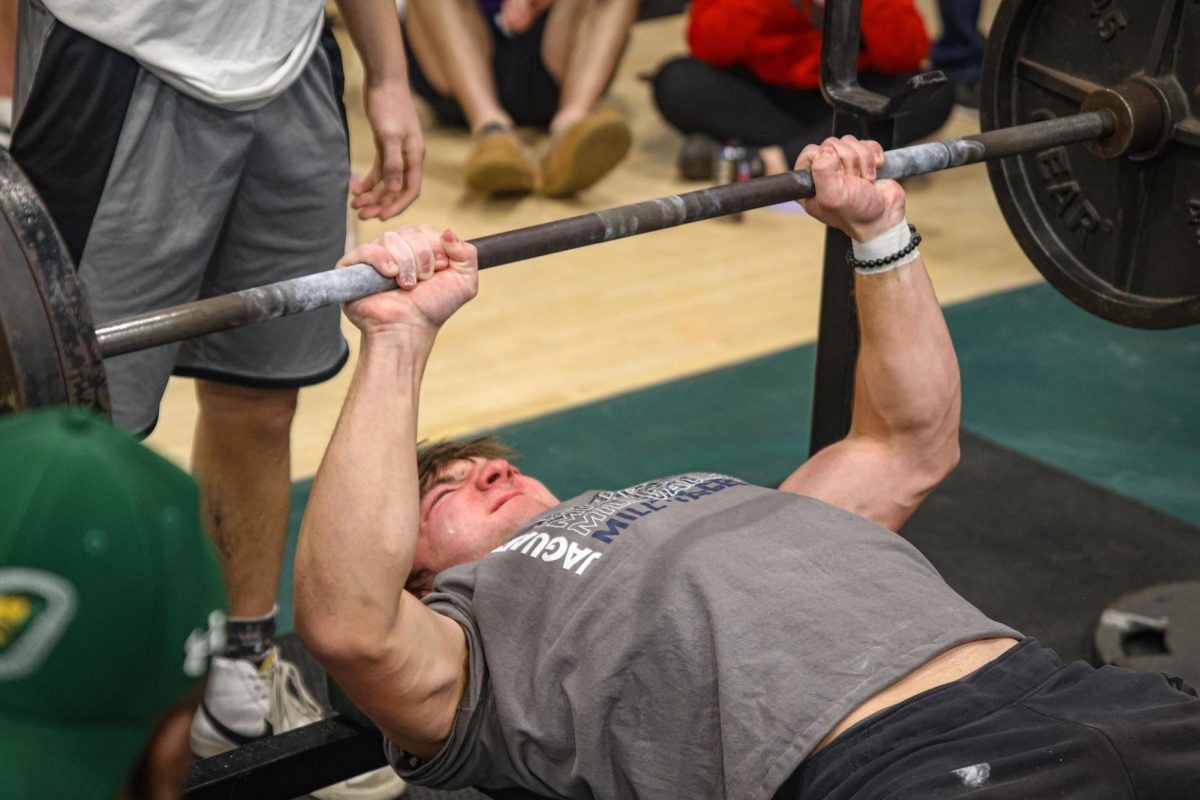 Focused on the bar, freshmen Nick Jenkins completes his final bench attempt.