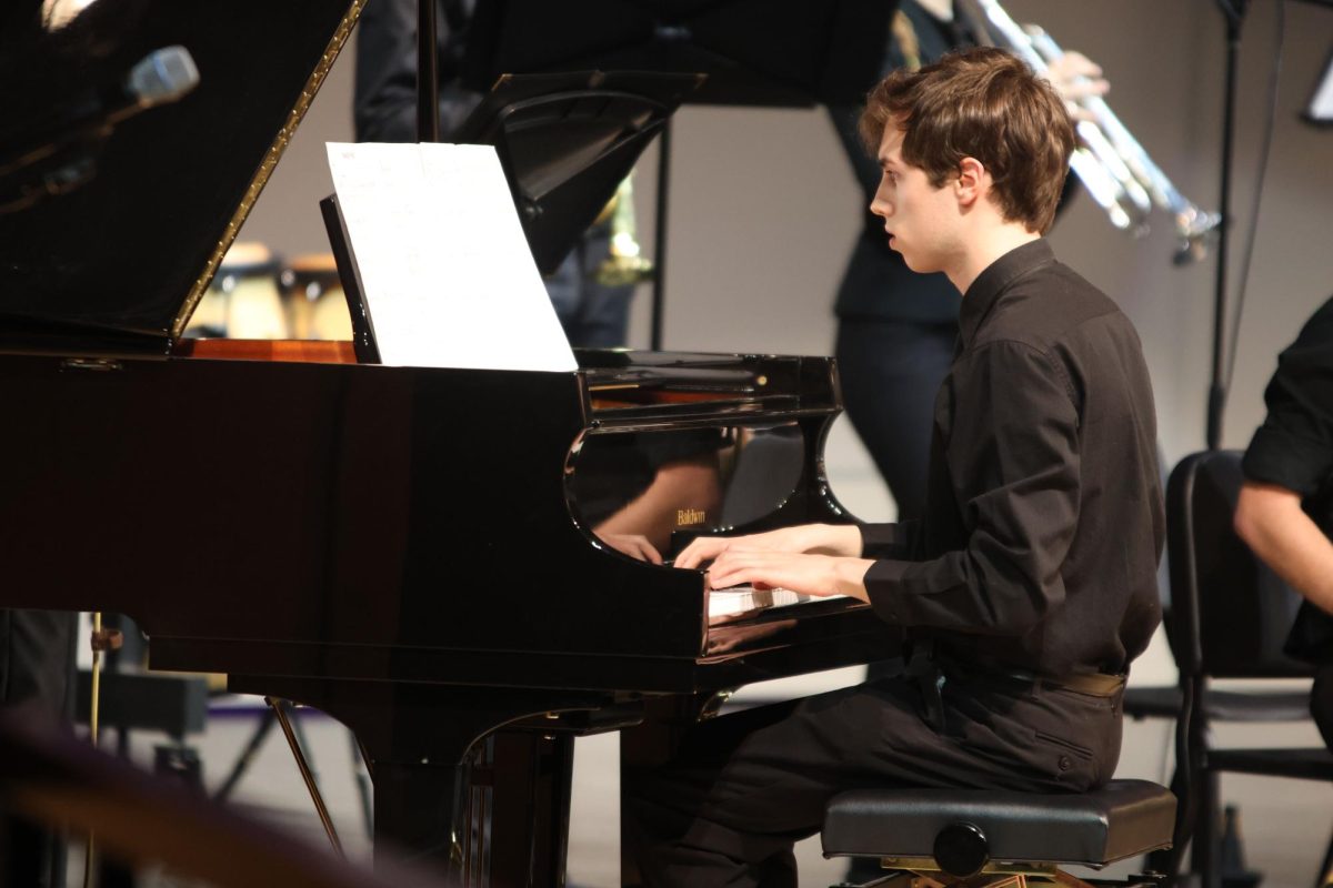 Hands on the keys, senior Nathan Anderson plays the piano during the Jazz Bands performance.