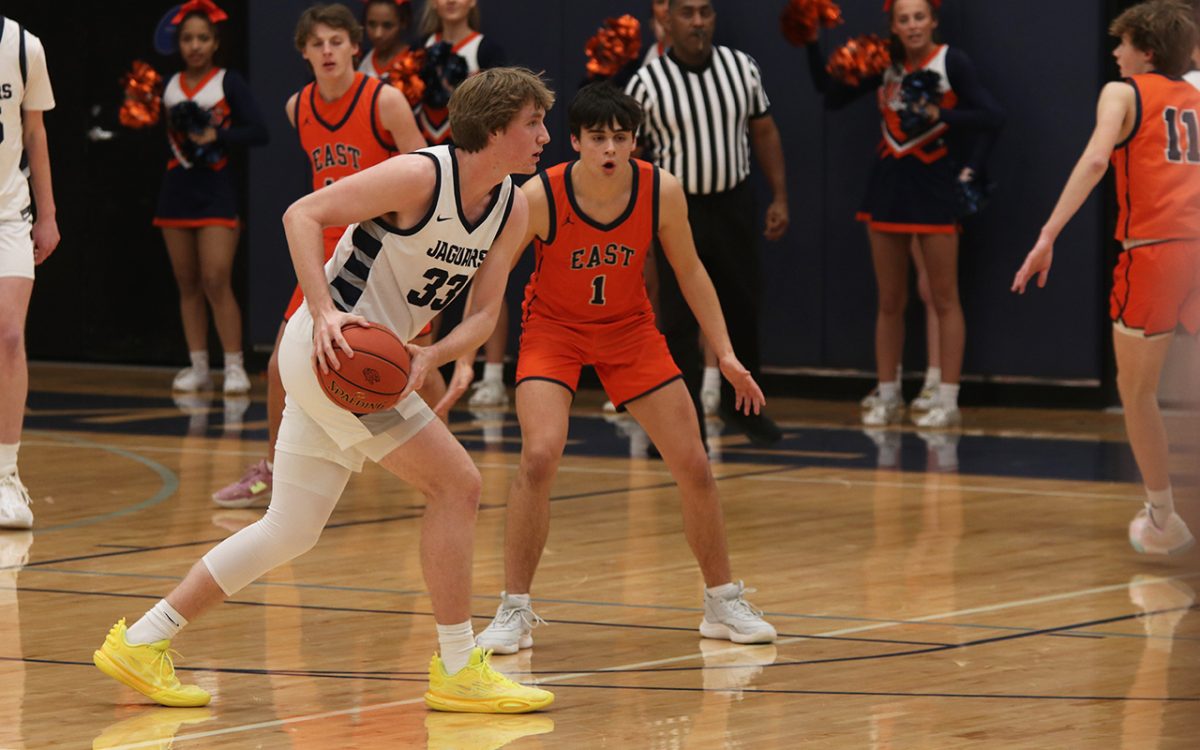 On his way to score, senior Mason Kemp plans his way to successfully get to the basket.