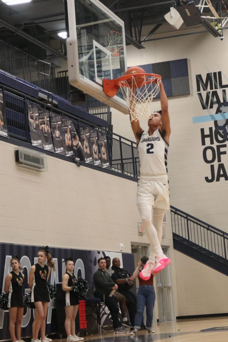 Sophomore JaKhai Carter dunks the ball against Lawrence Free State.