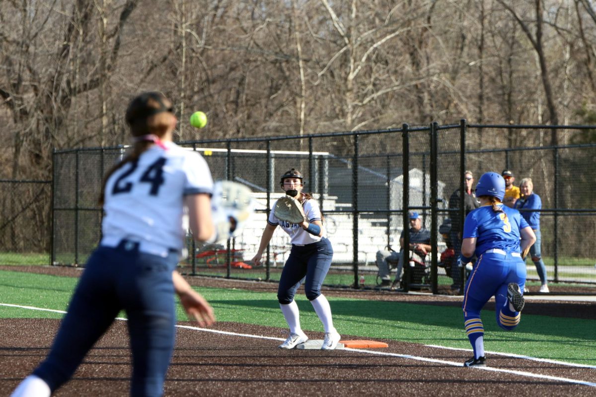 Sophmore Emma Hadley throws the ball to sophmore Makenah Brown in an attempt to get the runner out.