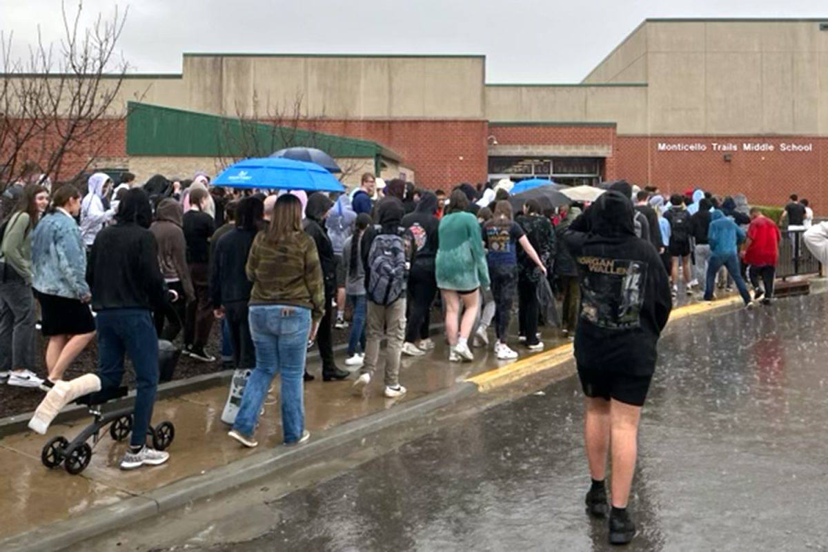 Trying to get out of the rain, students walk into MTMS.