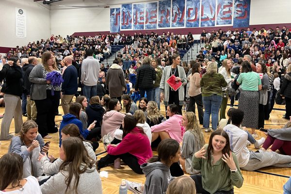 Surrounded by students on both the floor and the bleachers, teachers stand in the center of the MTMS gym.