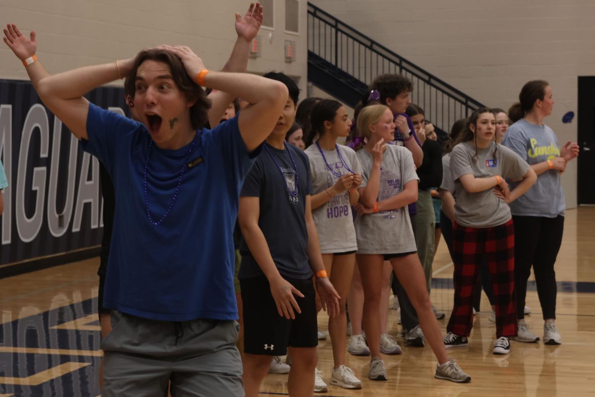 Junior Ronan Myers throws his hands up in shock during the kickball game. 