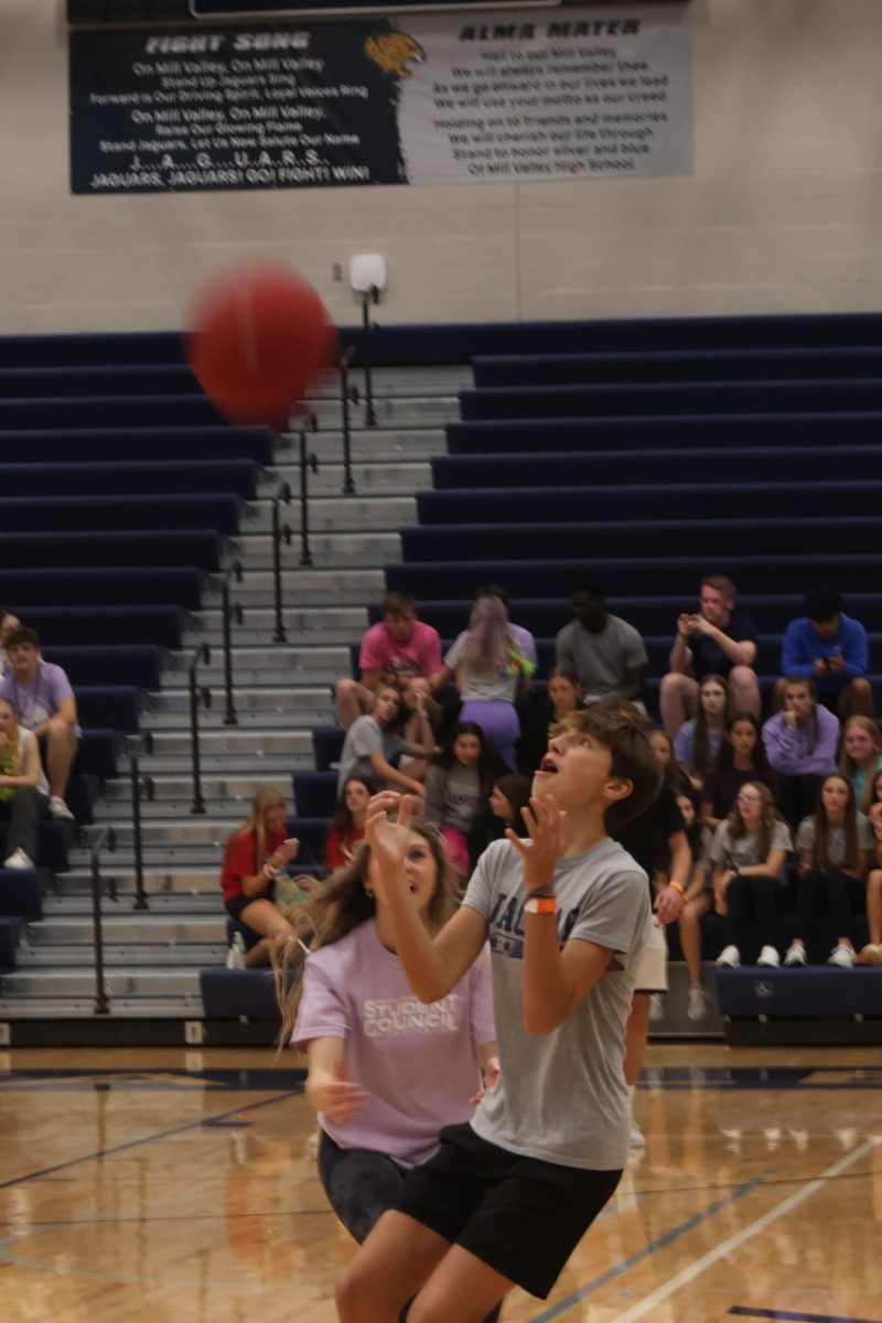 Freshman Jace Hutchins puts his arms out to catch the kickball. 