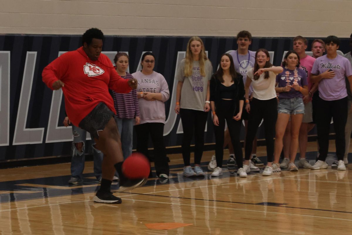 Senior Adam McClendon winds up to kick a foul ball in the senior versus sophomore kickball game. 