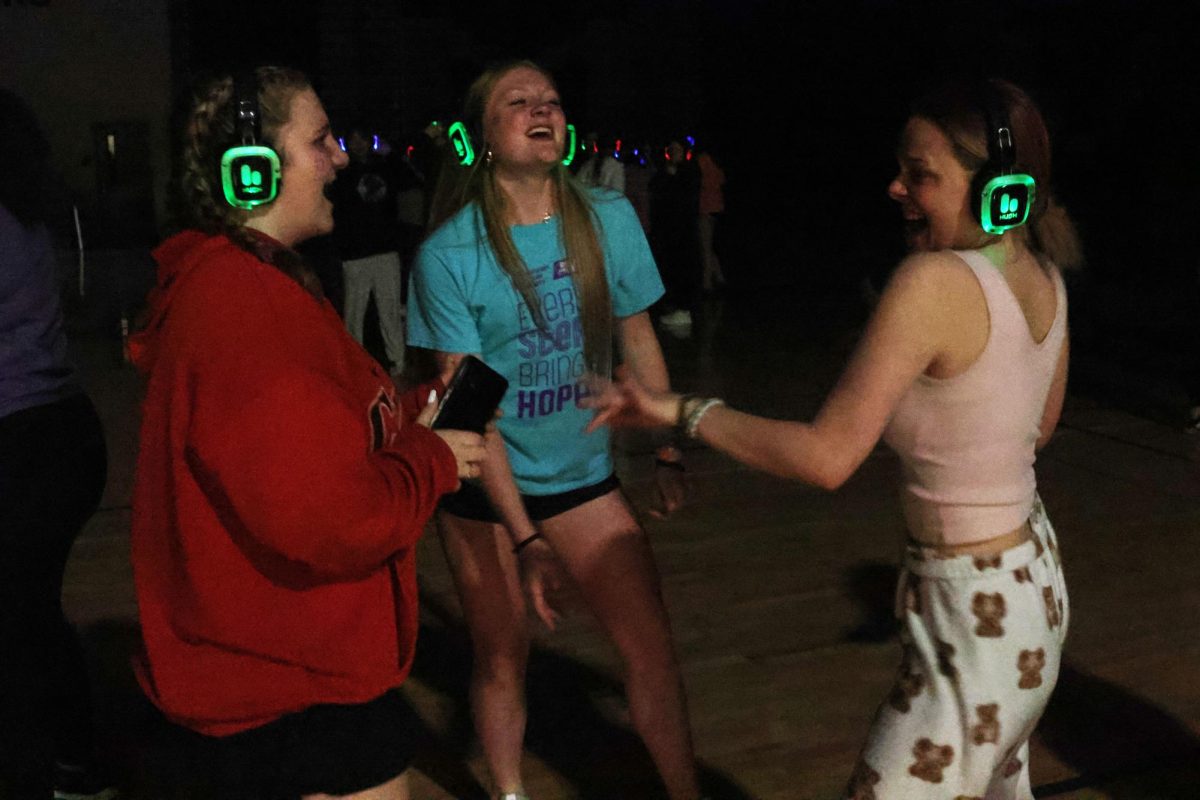 Sophomores Elaina Weese and Emma Carbajo and senior Kaylen Hyde dance at the Silent Disco. 