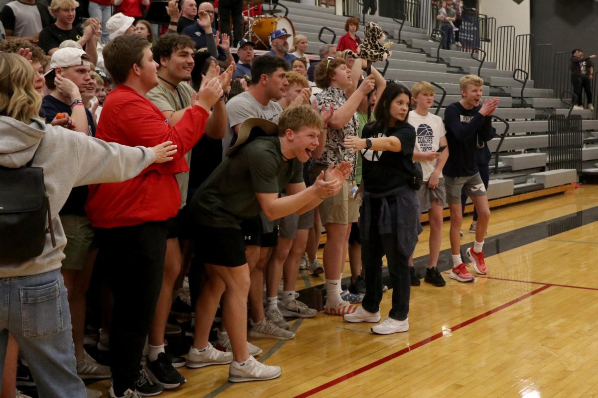 After the victory, senior Garrett Cronin along with the student section prepares to storm the court.