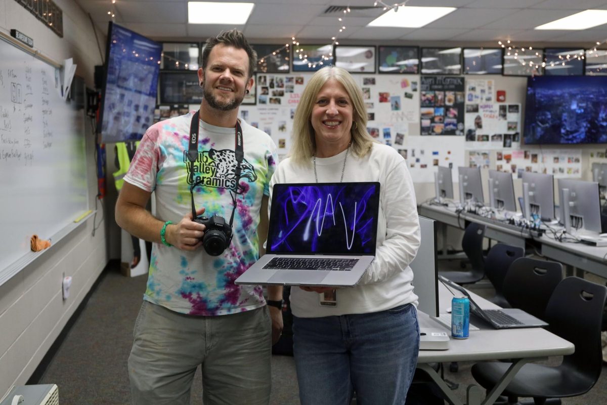 Holding a laptop and camera, journalism teacher Kathy Habiger and art teacher Brian Lloyd show the technology used in class to complete the light painting project assigned in both of their Photo Imaging classes. “I think there’s a lot more structure with Photo Imaging because its a technical class where you have to work the cameras and use the software on the computers in a specific way, Lloyd said. “There is a lot less structure with clay and art media because it’s more hands-on and less technology related.”