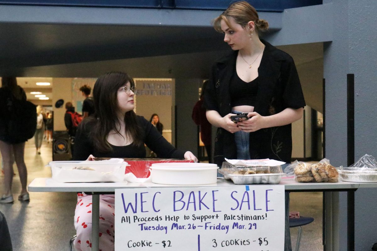 Womens Empowerment Club hosts a bake sale to support displaced women in Gaza. Club president, senior Ryleigh McCall looks to senior Kaelyn Russell as they discuss their plans for the bake sale Friday, March 29.