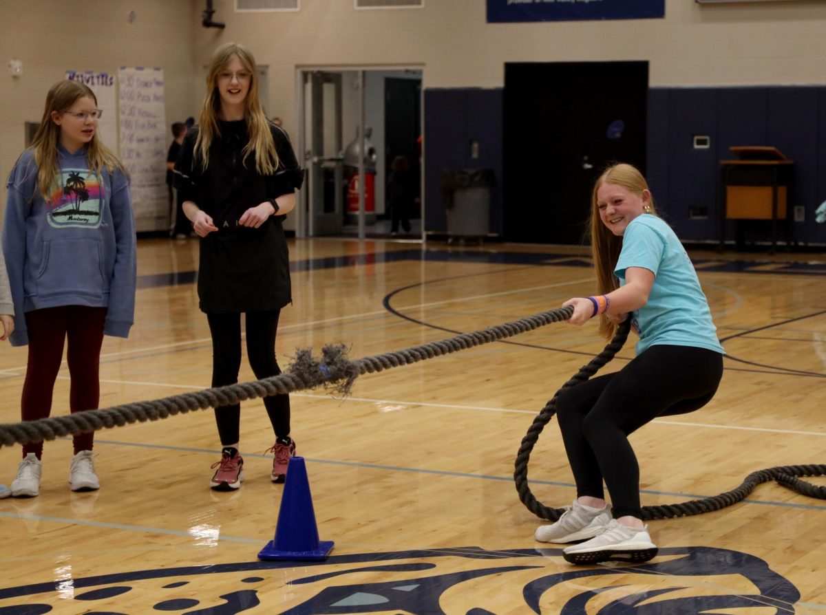 Pulling on the tug-of-war rope as hard as she can, sophomore Emma Carbajo participates in one of the many Relay for Life activities. 