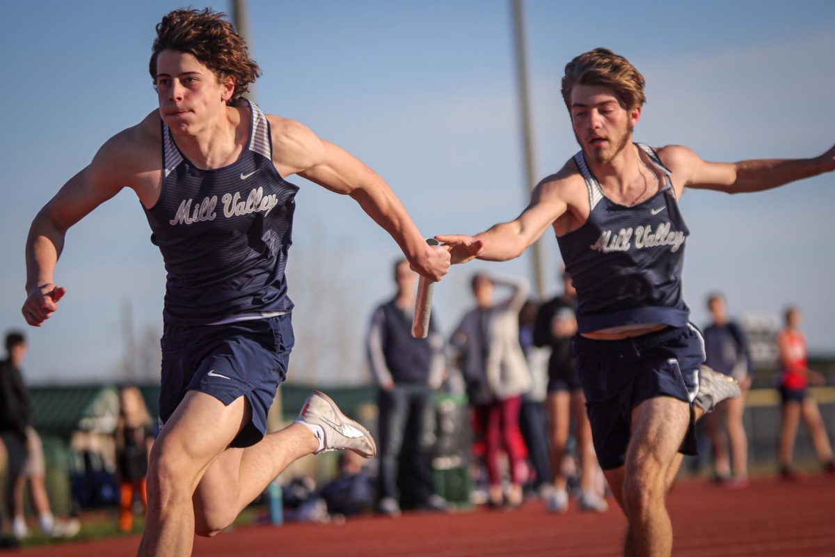 Passing the baton, freshman Haydn Legleiter hands off to junior Braden Peter.