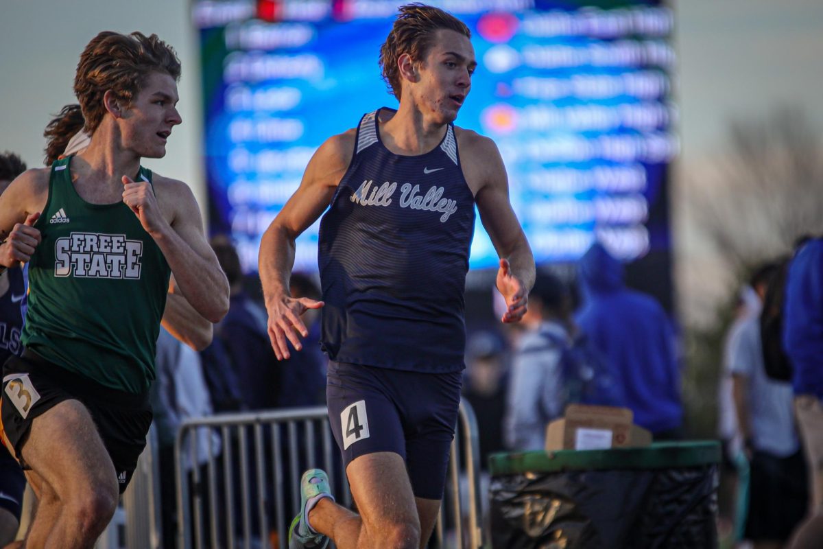 Leading the race, junior Carter Cline rounds the curve in his 800 meter race.