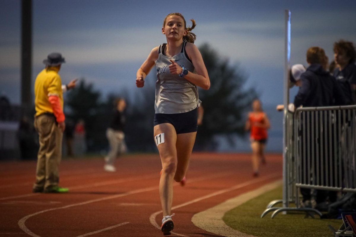 Focused, junior Meg McAfee runs the last lap of her race.