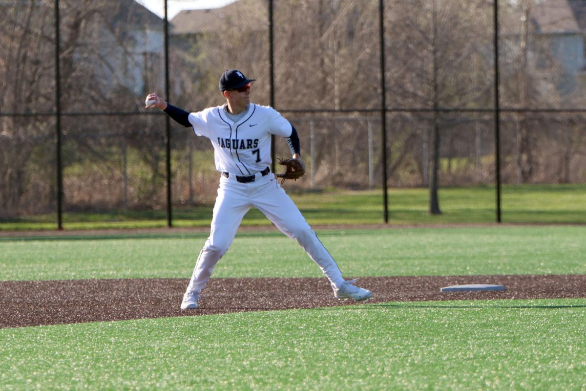 Finishing the play, senior Aaron Gallimore lines up to throw the ball to first.