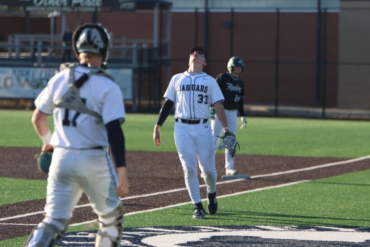 Searching for the ball, sophomore Drew Yockey lines himself up to catch a pop fly. 