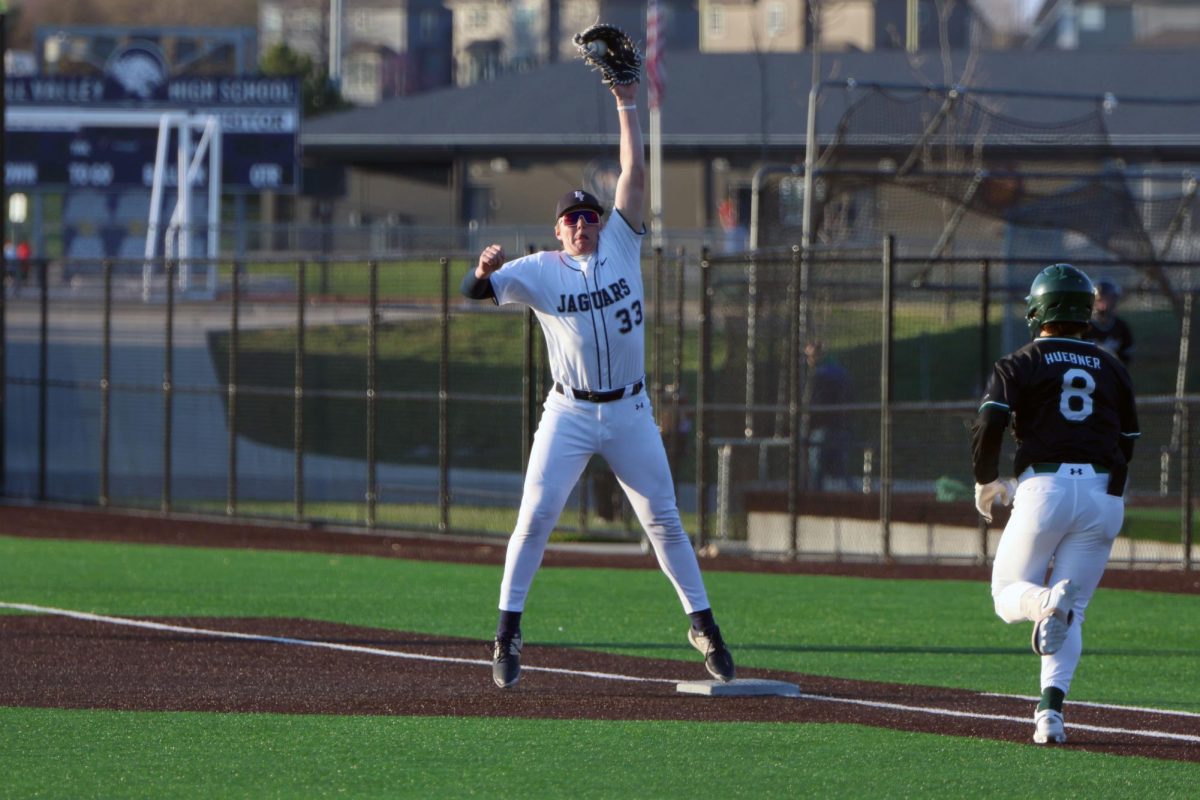 Sophomore Drew Yockey stretches as high as he can to catch a ball from the catcher.