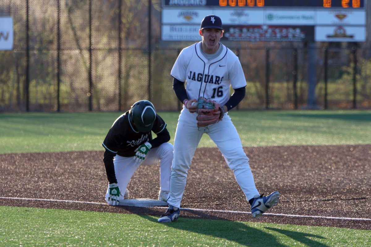 Celebrating a thrown out baserunner, sophomore Beau Peterson screams in excitement. 