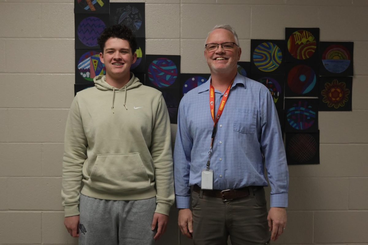 Science teacher Chad Brown poses with his son sophomore Miles Brown.